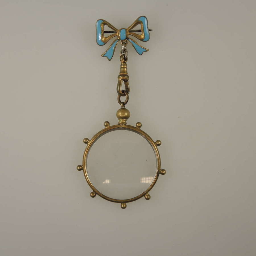 Victorian gilt metal and enamel bow pin with frame locket c1890
