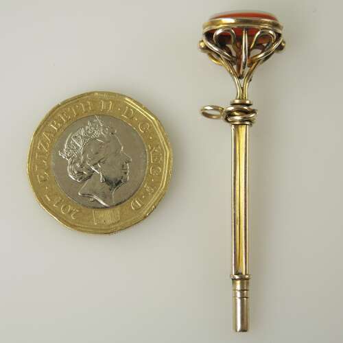 Victorian gilt cased pocket watch key set with an agate base c1850