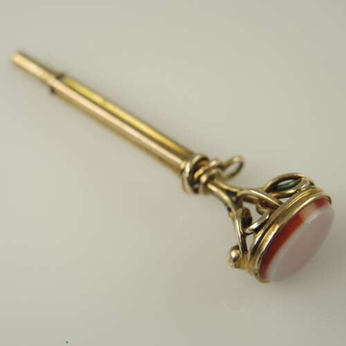 Victorian gilt cased pocket watch key set with an agate base c1850