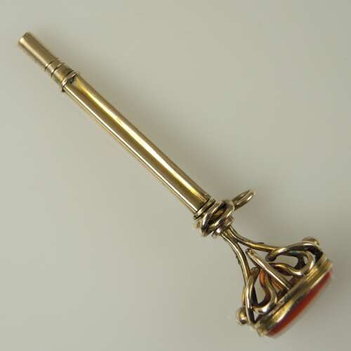 Victorian gilt cased pocket watch key set with an agate base c1850