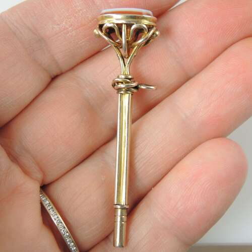 Victorian gilt cased pocket watch key set with an agate base c1850