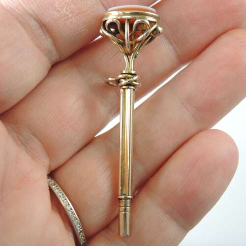 Victorian gilt cased pocket watch key set with an agate base c1850